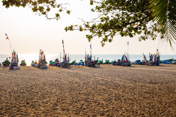 sandy sea promenade with trading tables and folded umbrellas at the fishermen's morning market
