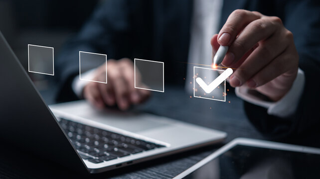 Businessperson completing digital checklist on laptop. Concept of productivity and task management. Useful for project planning, organizational strategy, and corporate efficiency visuals.