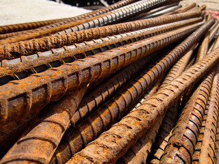 A rusty metal bars is stacked at the construction site