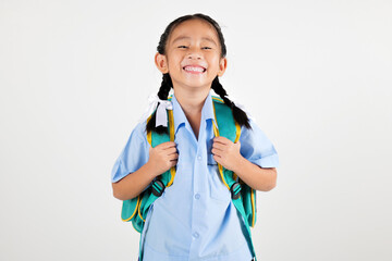 Portrait smiling Asian little girl kindergarten with schoolbag studio shot isolated white...