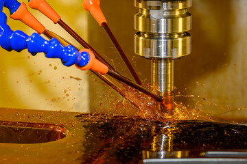 The CNC milling machine rough cutting the mold parts by indexable tool with liquid coolant method.