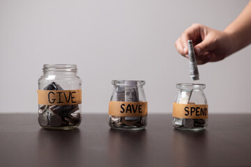 Manage her money wisely, she used glass jar to save coins, deciding when to spend or save as part...