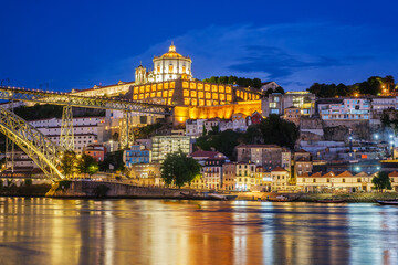 View of Vila Nova de Gaia city with Mosteiro da Serra do Pilar monastery and Dom Luis I bridge over Douro river in evening twilight. Porto, Vila Nova de Gaia, Portugal