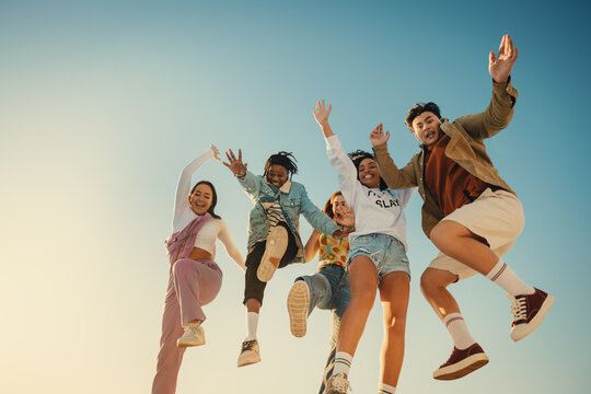 Group of happy friends jumping and having fun on a sunny day
