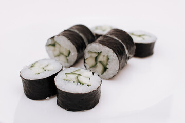 Maki sushi rolls with cucumber and avocado on plate