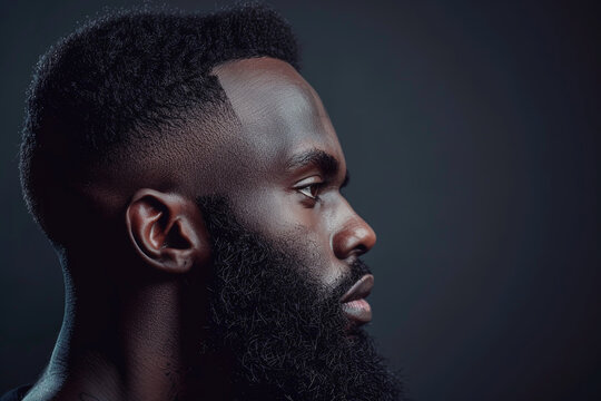 Photo of black man with beard in haircut and fade style, side view