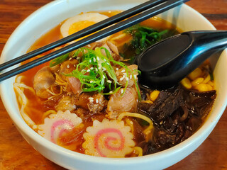 A close picture of a complete and fresh bowl of ramen