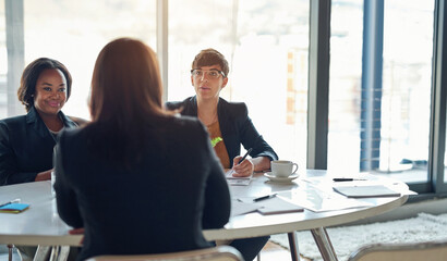 Interview, meeting or planning with business people at table in boardroom of office for...