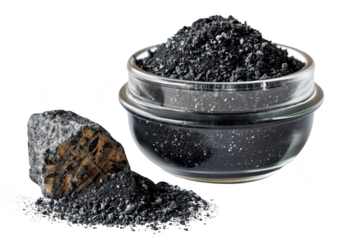 A clear bowl filled with black charcoal powder beside a piece of charcoal on a white background. Ideal for beauty, skincare, and health themes.