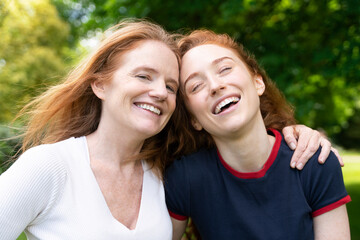 Fototapeta premium Happy Redhead Mother and Daughter Laughing Together in Park