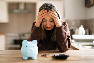 Worried Woman Calculating Finances With Piggy Bank and Calculator