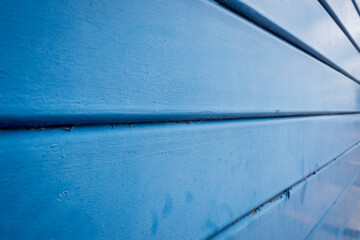 close up of a blue metal shutter door with shallow depth of field