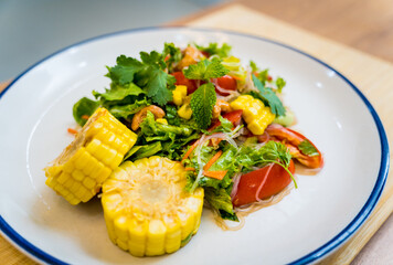 Spicy glass noodle salad on the white plate