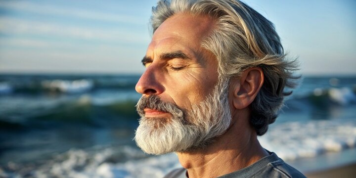 Serene Older Man Meditating on the Beach at Sunset