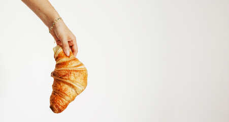 Banner with Hand holding croissant on transparent background. Copy space for text