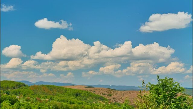 Nature landscape cumulus clouds rolling over hills and mountains time-lapse