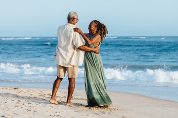 Elderly couple shares a romantic dance on the beach