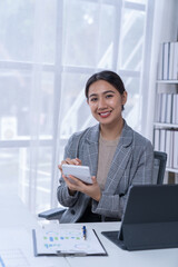 Bussiness women using laptop and smartphone working in the office