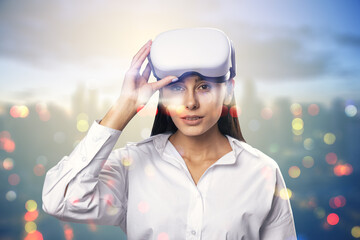 Portrait of attractive young european businesswoman with VR glasses standing on blurry bokeh city...