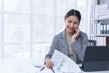 Bussiness women using laptop and smartphone working in the office