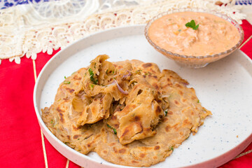 Laccha Onion Paratha . Popular Indian flat bread made with wheat flour and onion. Pyaz ke parathe in Hindi. Selective focus on Paratha . 