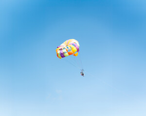 couple parasailing high in the sky
