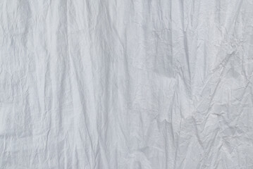 Crumpled white paper background.