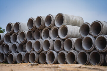 A stack of concrete ring pipes piled and creating a symmetrical arrangement