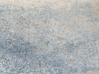 Fototapeta premium A white wall with a hole in it. The wall is cracked and has a rough texture