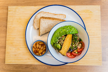 Healthy quinoa bowl with avocado, mushrooms and fresh vegetables