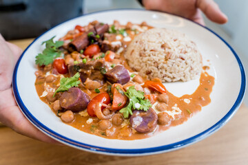 A vegetarian massaman curry in a bowl with sweet potato and many spices
