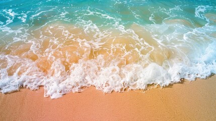 Clear ocean waves gently lapping against a colorful sandy beach