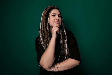 Woman With Dreadlocks Standing in Front of Green Wall