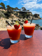 Summer strawberry drink  and peanut against the backdrop of the sea. Close-up. Spain.