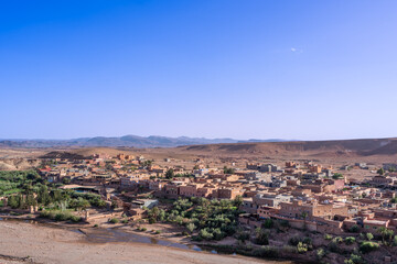 Obraz premium View of Ouarzazate from the Kasbah of Ait Ben Haddou. River dry season.The Berbers built many mud-house Kasbah near the Ait Ben Haddou Gorge, Morocco.