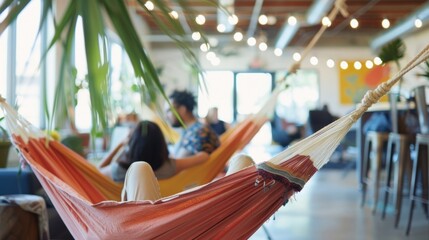 Through the outoffocus background we catch a glimpse of a vibrant startup work culture with employees engaged in brainstorming sessions relaxed in hammock chairs and fueled by an endless .