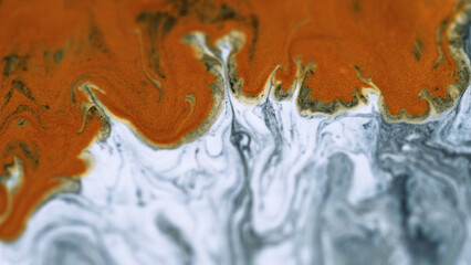 Shiny ink splash. Marble paint texture. Defocused white gray orange color metallic glitter...