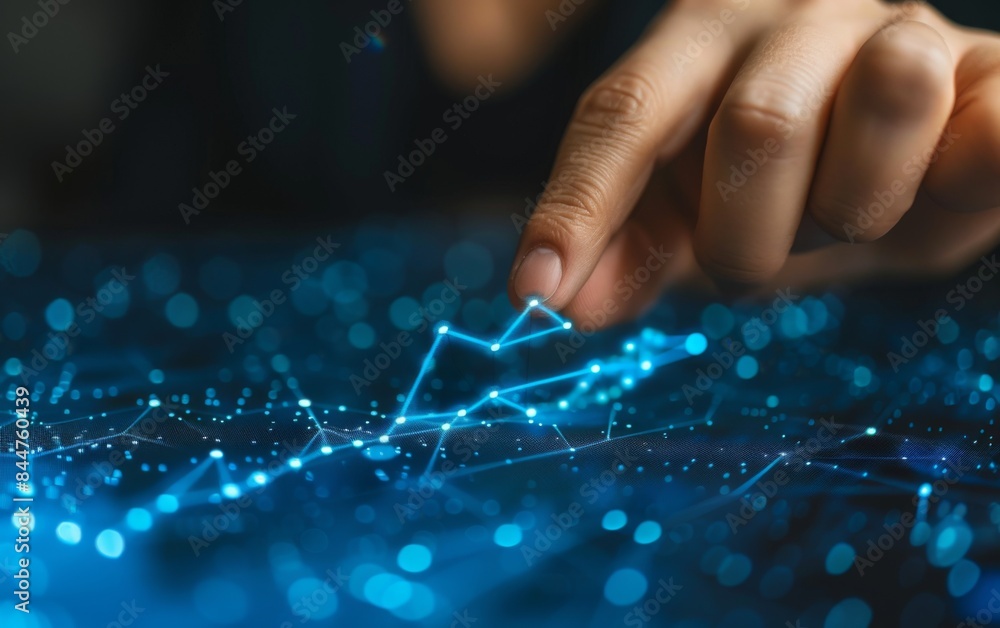 Poster a hand is pointing at a blue line on a screen. the line is made up of small dots, and the hand is ho