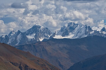 Russia. The North Caucasus. A stunning view of the peaks of the Caucasus Range from the snow-covered slope of Europe's highest mountain Elbrus.