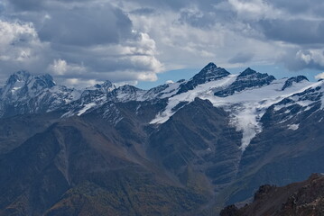 Fototapeta premium Russia. The North Caucasus. A stunning view of the peaks of the Caucasus Range from the snow-covered slope of Europe's highest mountain Elbrus.