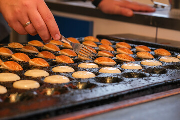Process of Poffertjes - traditional small Dutch pancakes - making.