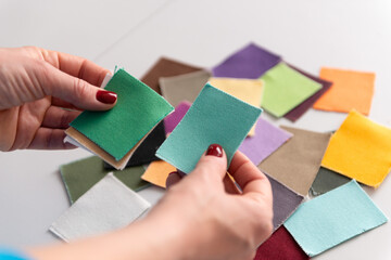 person holding color samples of cotton fabric