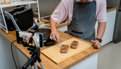The chef is broadcasting live from workshop how to prepare a beef steaks on the electric grill