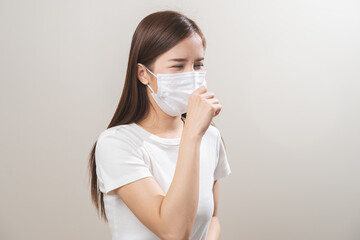 Unhealthy sickness, unwell asian young woman wearing mask coughing, have sore throat, suffering symptom cough feeling bad and healthcare of air pollution and dust, PM2.5 isolated white background.