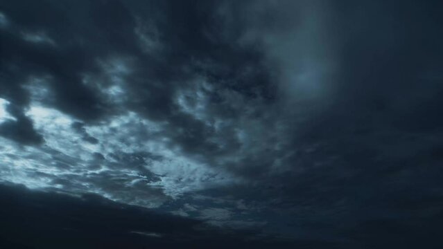 Impressive and immense storm cloud moving in the sky, with internal flashes of lightning
