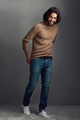 Smile, man and portrait with fashion in studio for elegant, style and comfortable winter jeans...