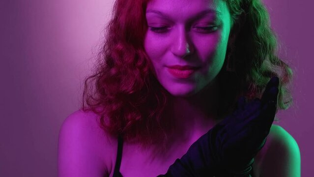 Evil woman. Cunning smile. Pretty glamour female scheming rub hands black gloves evening dress think revenge sneaky plan neon green violet gradient.