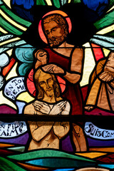 Stained glass representing the baptism of Christ. Vitrail représentant le bâptème du Christ. Annecy - France