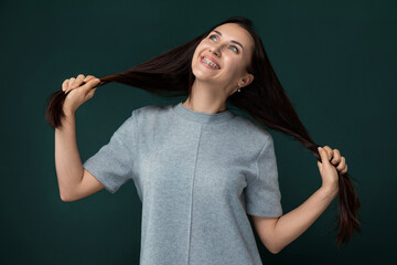 Woman With Long Hair Against Green Background