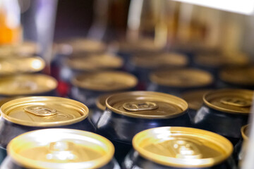 
metal cans in black color stacked on store shelves in a symmetrical row